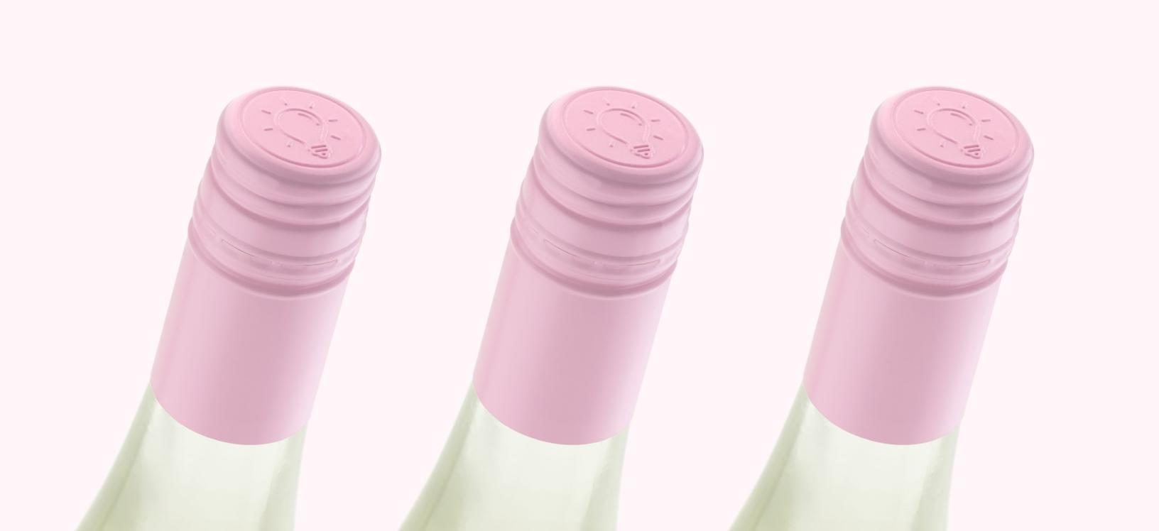 Pink wine closures on riesling bottles in a row