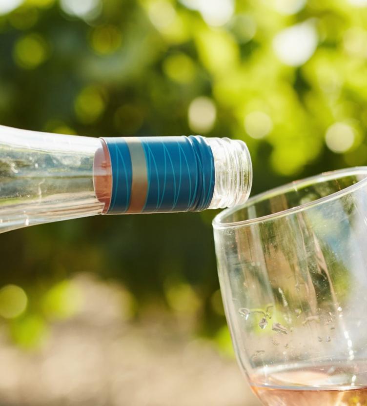 Wine closure on bottle pouring wine