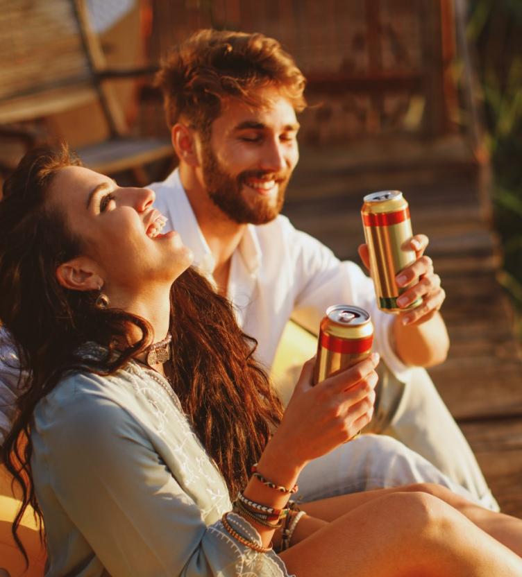 Two people drinking from cans