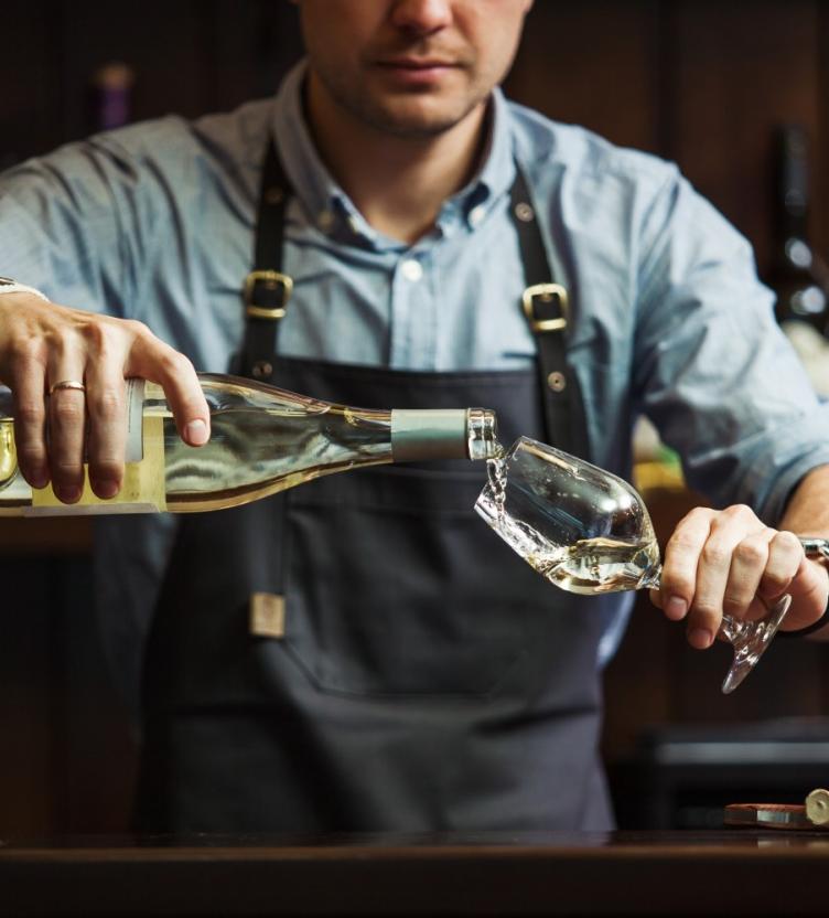 Bartender pouring glass of wine