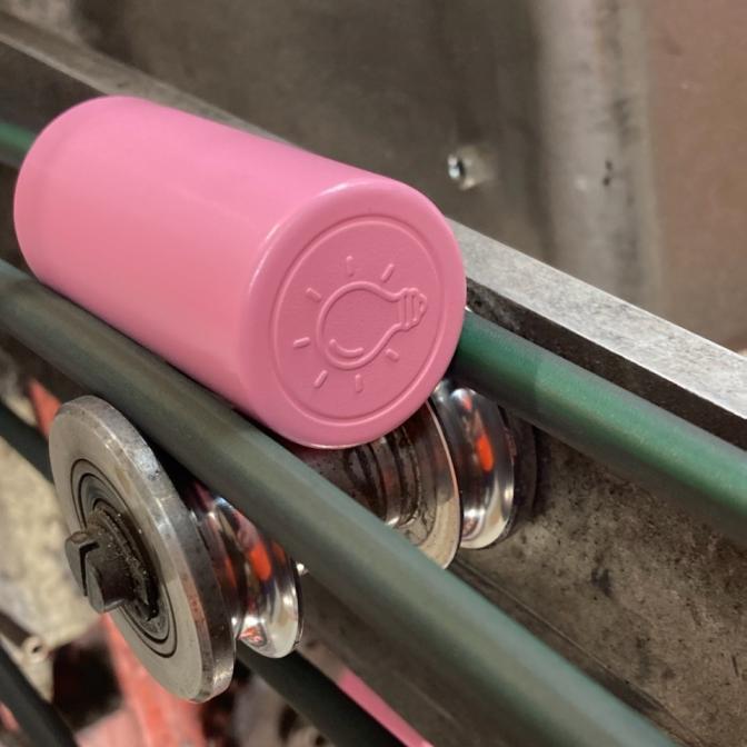Pink wine closures on manufacturing line