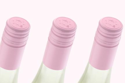 Pink wine closures on riesling bottles in a row